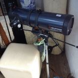 A CELESTRON ASTROMASTER 130 TELESCOPE ON STAND