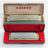 Two Hohner harmonicas 'Chromonika III' & 'The Super Chromonica'.