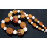 A strand of amber and ivory beads, length 46cm, gross wt. 89.2g, beads ranging from 8mm - 25mm.