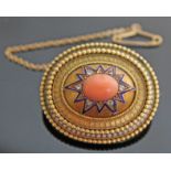 A Victorian yellow metal target brooch with central coral cabochon surrounded by diamonds and blue