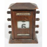 A 1920s oak perpetual calendar, height 16.5cm.