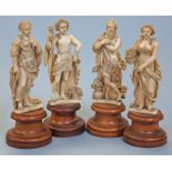 A set of four Dieppe ivory carvings allegorical of the Four Seasons, mid 19th Century, on turned