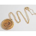 A Victorian photo pendant, diam. 26mm, marked '9c', on unmarked yellow metal chain, length 44cm,