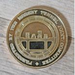 A yellow metal medallion 'Presented by the Mersey Tunnel Joint Committee'.