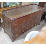 A Georgian oak mule chest, having fluted quarter columns, six dummy drawers above three drawers with