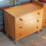 A 1960s light oak chest of three drawers with turned knobs and spindle legs by Meredew, width