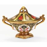 A Royal Crown Derby Old Imari 1128 sucrier and lid, length 18.5cm. Condition - marked as second