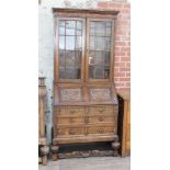 A carved oak bureau bookcase with pull out fitted interior circa 1920, width 101cm, depth 53cm &