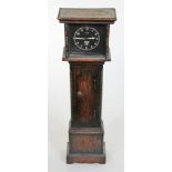 A Smiths car clock housed in as a miniature long case clock, height 37cm.