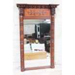 A 19th Century rosewood mirror with beaded cornice and turned half columns, 47cm x 74cm.