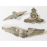 A group of three military badges comprising an RAF badge marked 'Silver', a hallmarked silver