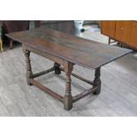 A 17th Century joined oak refectory table with later top having moulded edge, base with turned