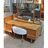 A 1960s triple mirror dressing table with turned spindle drawer pulls, spindle legs and stool by