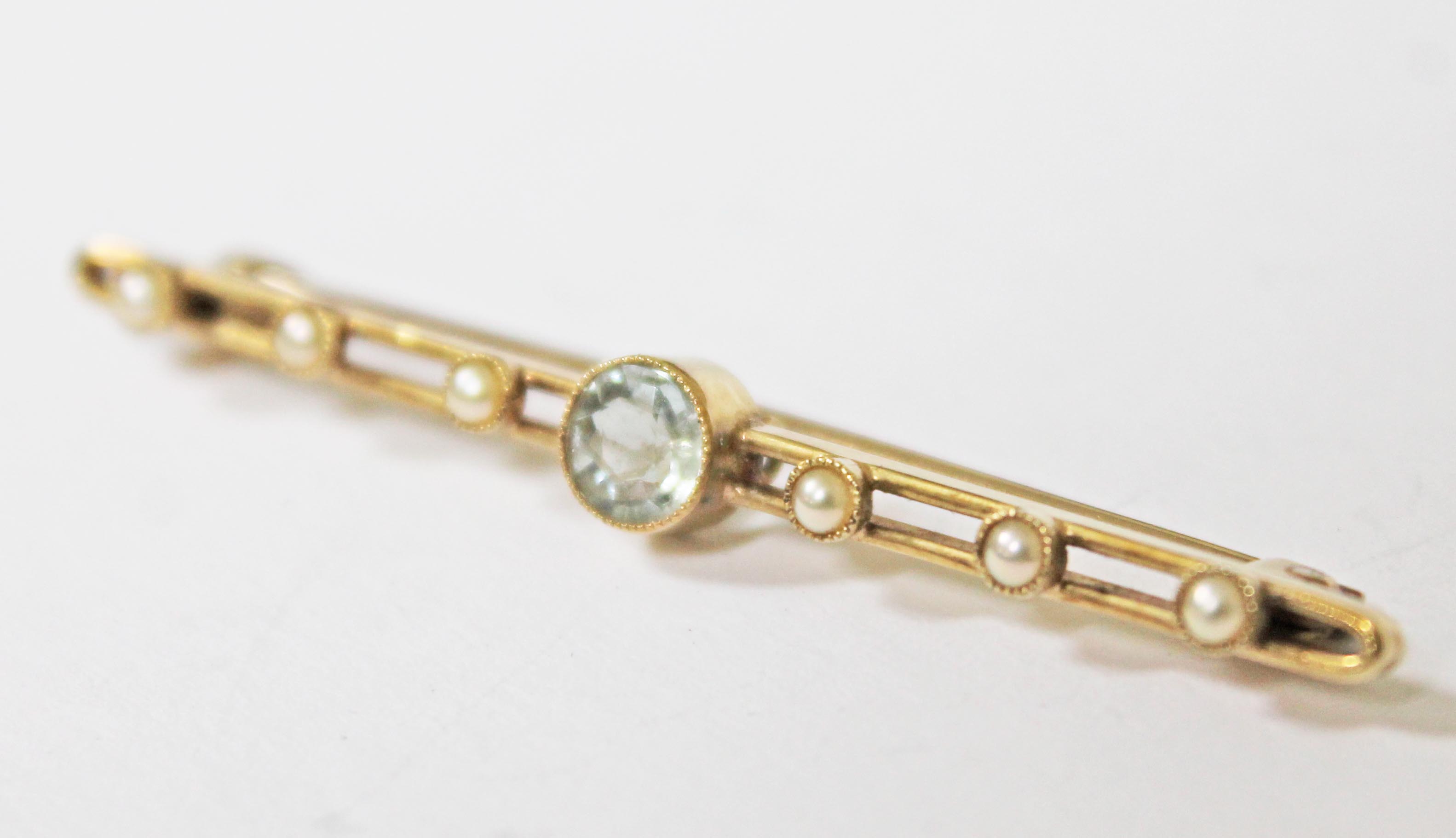 A yellow metal brooch set with an aquamarine coloured stone and half cut pearls, length 5cm, - Image 2 of 2