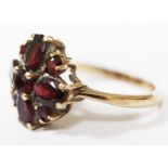 A hallmarked 9ct gold ring set with red stones, gross wt. 3.3g, size N/O.