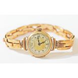 A ladies 9ct gold Vertex wristwatch on yellow metal Britannic strap, gross wt. 23.8g.