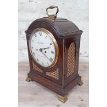 A Regency bracket clock having dome top with gilt brass handle, gilt brass grille sides, painted