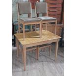 A Gordon Russell walnut extending table and chairs.