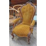 A Victorian walnut spoon back armchair.