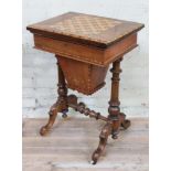 A Victorian walnut games or sewing table with parquetry inlaid chess top swivel and folding over