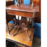 A reproduction mahogany side table on lyre pedestal and scroll legs.