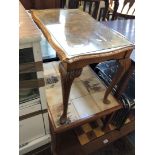 A reproduction figured walnut glass top coffee table.