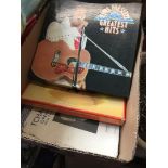 A box containing Elvis records, music sheets, etc