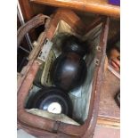 A pair of crown green bowls. in leather bag