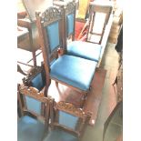 A drawer leaf oak refectory table with bulbous legs and a set of six carved oak chairs with blue