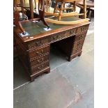 A reproduction leather top pedestal desk.