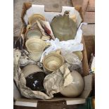 A box of stoneware pottery