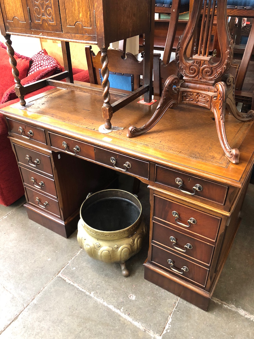 A reproduction tooled top pedestal desk.