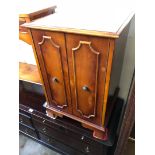 A yew wood hifi cabinet and another small table.