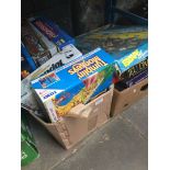 2 boxes containing various boxed games including Monopoly, Pictionary, etc