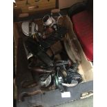 A box of fishing reels and other items including saws and fishing knives