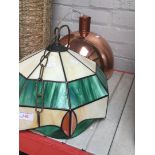 A tiffany lampshade and a copper lampshade