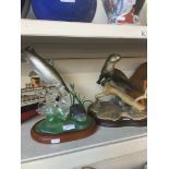 A trout figurine and an otter figurine