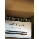 A PSP and box of games