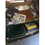 2 boxes of stamps and stamp albums