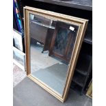 A gilt framed mirror.