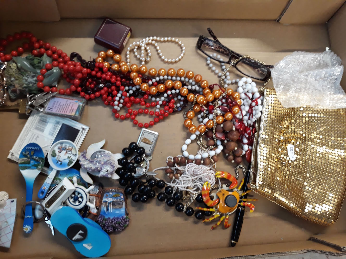 A box of mixed costume jewellery, magnets etc