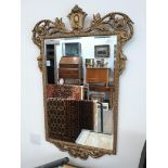 An ornate gilt framed mirror, 69cm x 105cm.