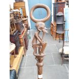 An African carved hardwood walking cane, length 94cm.