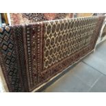 A beige ground Bokhara style carpet, 180cm x 200cm.