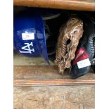 A baseball helmet with a mini helmet and 2 baseball gloves