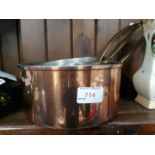 A set of three copper and brass pans