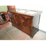 A 1930s oak mule chest with geometric panels