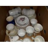 A box of misc saucers, cups and mugs