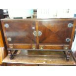 A 1930s oak sideboard with brass bound fittings