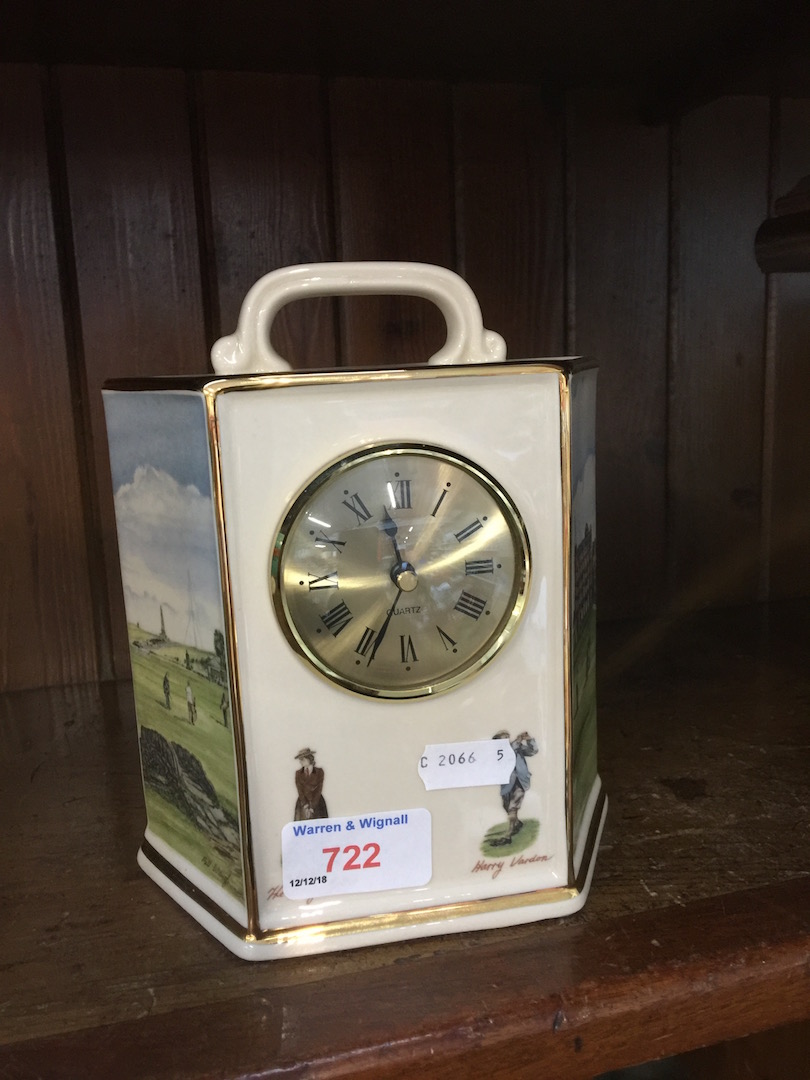 A mantel clock showing a golf scene